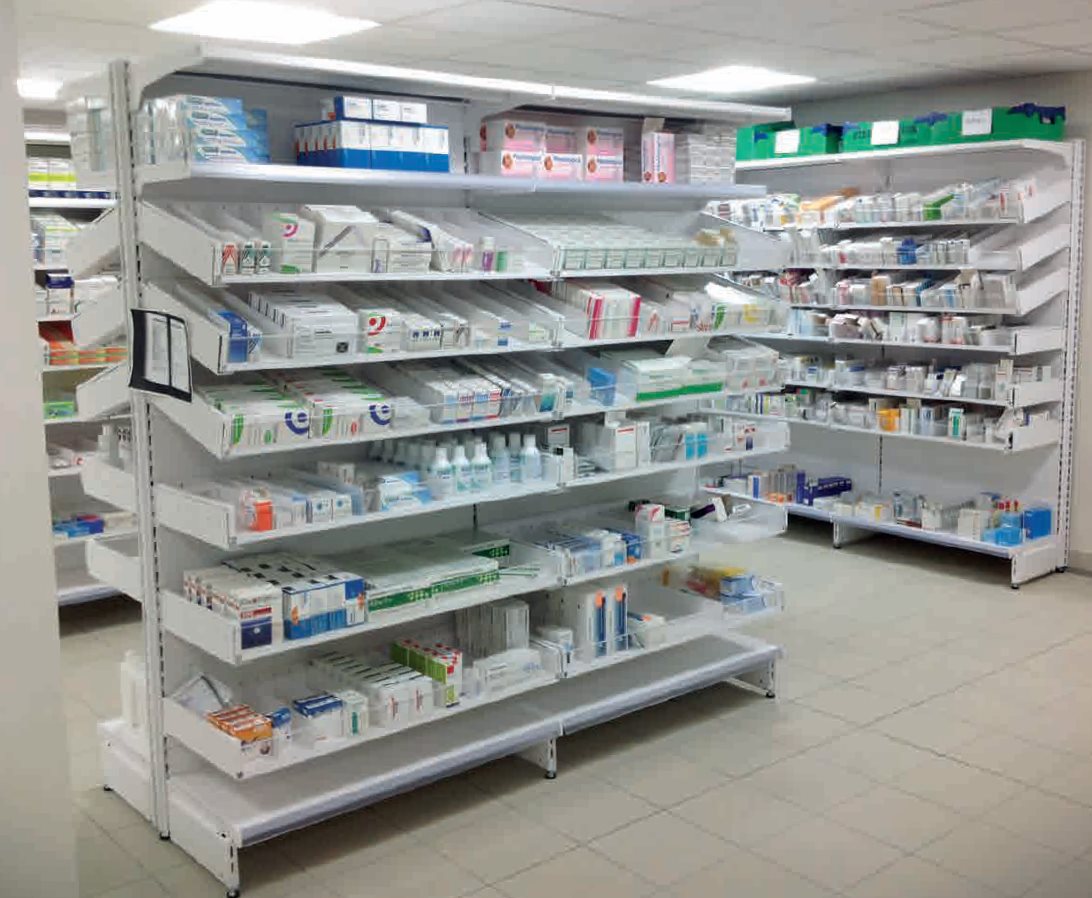 Hospital pharmacy shelves organized with medication bottles and supplies