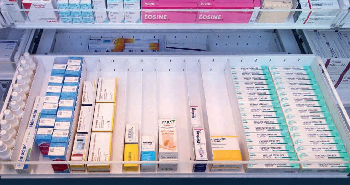 Pharmacy medication shelves with neatly organized drugs and supplies