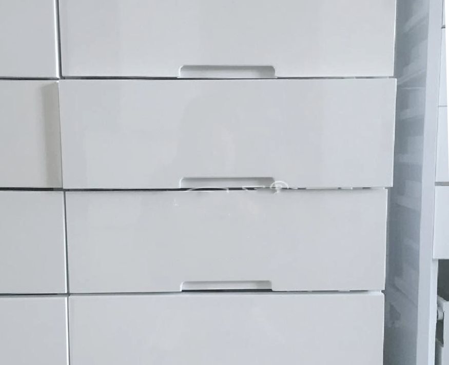 Sleek white pharmacy drawer system with minimalist design