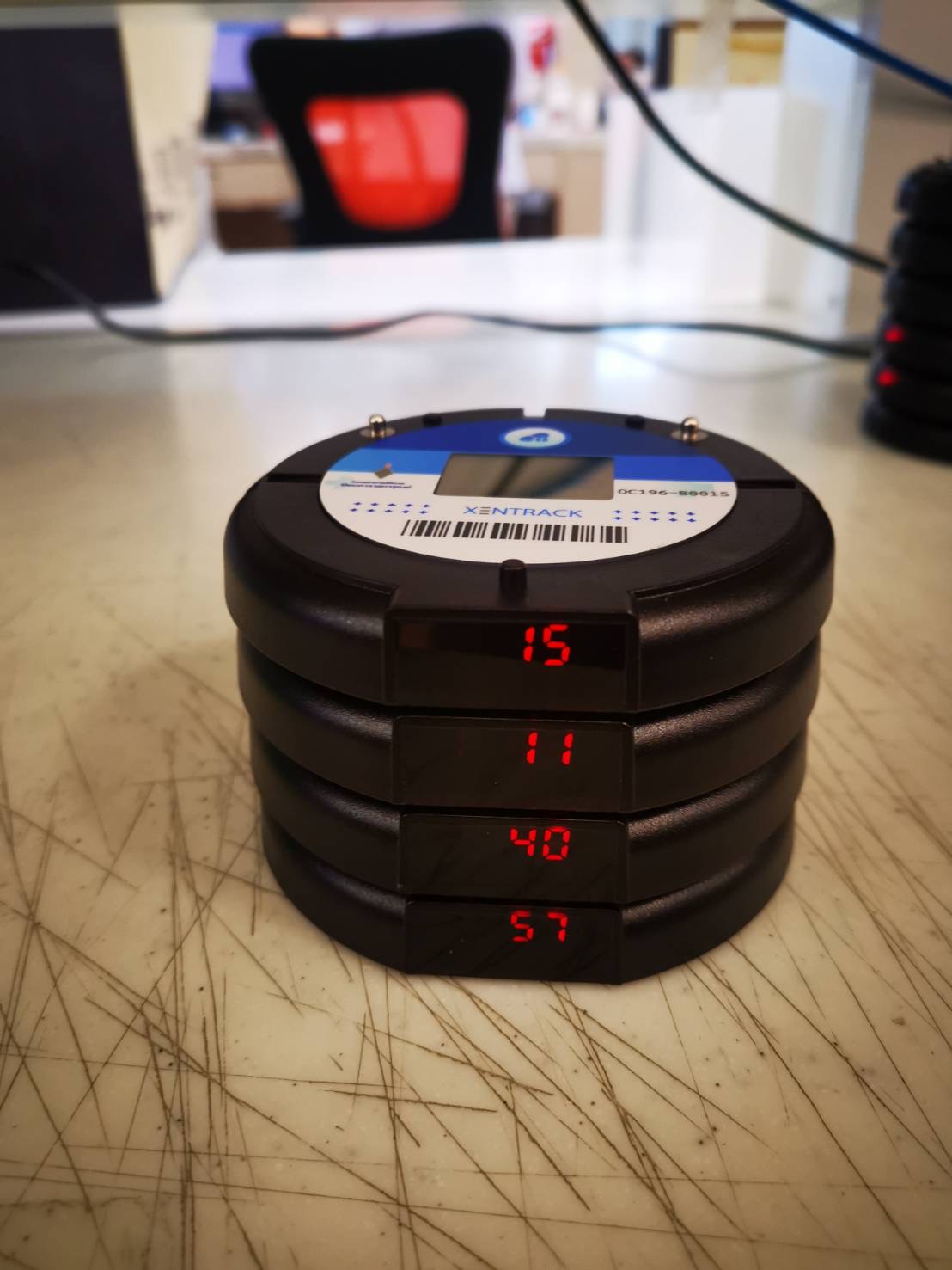 Stacked beeper display showing multiple IDs in a hospital pharmacy. | จอแสดงบี๊บเปอร์ที่เรียงซ้อนกันหลายตัวในห้องยาโรงพยาบาล